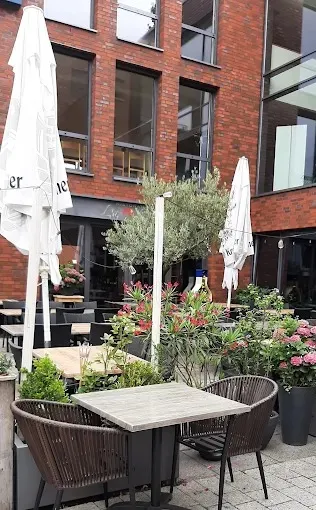 Außenbereich des Ristorante La Rosa in Stadtlohn mit Tisch, Korbstühlen und Oleander